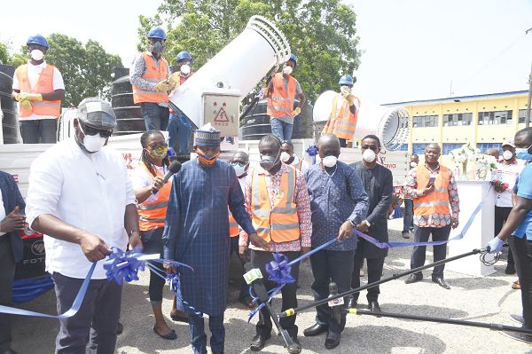  Mr Aminu Mohammed Zakari, the Ayawaso North Municipal Chief Executive, cutting a tape to launch the new disinfecting equipment. Looking on are Dr Mathew Opoku Prempeh (left), Prof. Kwasi Opoku-Amankwa (2nd right) and Rev. Ebenezer Kwame Addae (3rd right), the Head of the Vector Control Unit of Zoomlion. Picture: Emmanuel Quaye