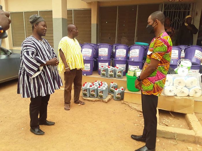 The Bolgatanga East District Director of Health Services,Mr Eugene Osei(first right) and the Representative of the Zuarungu Chief,Mr Lawson Asampana(wearing smock first left) during the donation.Note: Social distancing being observed.