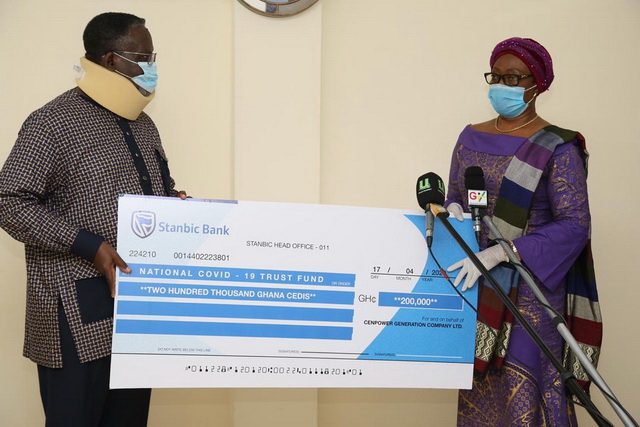 Dr Jimmy Heymann presenting the cheque to the Chairperson of the Board of Trustees for the National COVID-19 Trust Fund, Madam Sophia Akuffo