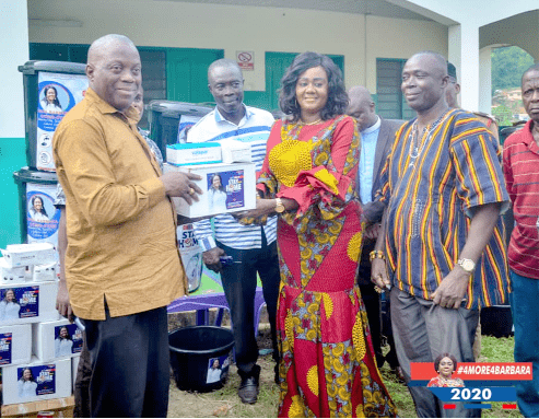 Mrs Oteng-Gyasi (2nd right) presenting the items to Mr Tamakloe while the Chief of Bogoso, Nana Sumpre (extreme right), and Mr Abiam Kuntu Danso (middle), NPP Chairman of the Prestea Huni-Valley Constituency, look on