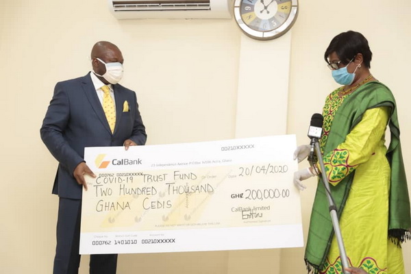 Mrs Sophia Akuffo (right), Chairperson, National Covid-19 Trust Fund receiving a cheque for GH¢200,000 from Mr Philip Owiredu, Managing Director, CalBank. Picture: SAMUEL TEI ADANO