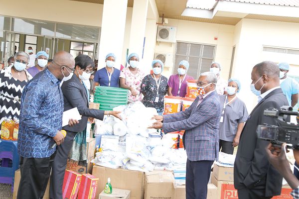  Justice Sophia Akuffo (2nd left) handing over the sanitary items to Dr Ali Sanda