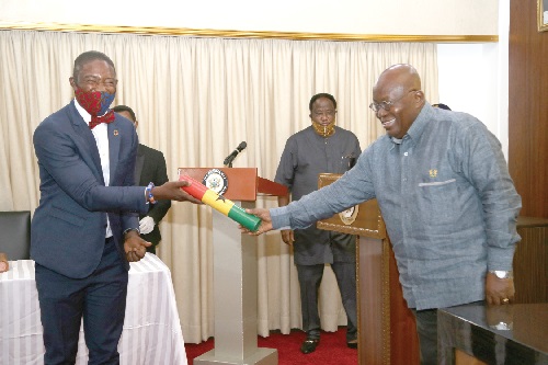 President Nana Addo Dankwa Akufo-Addo presenting the instrument of Office to Dr Bernard Okoe Boye (left), the new Deputy Minister of Health. Picture SAMUEL TEI ADANO
