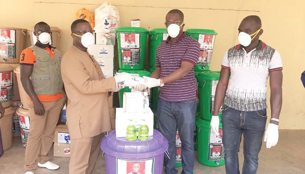 The Disease Control Officer, Mr Michael Linsey (2nd right), receiving the items from Mr Adomako-Mensah