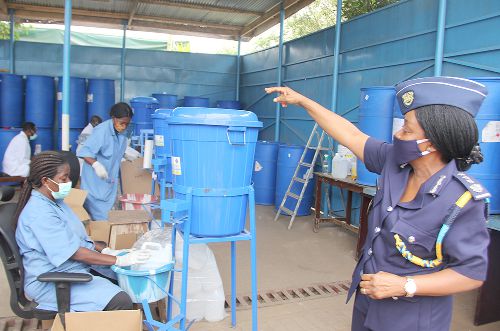 Ms Phyllis Sakyi-Djan (right), Acting Assistant Commissioner in-charge of Customs Laboratory, Customs Division of the Ghana Revenue Authority, taking participants through the production processes of the hand sanitiser during a visit to the facility. Picture: EDNA SALVO-KOTEY