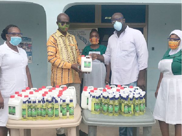  Dr Asamoah Kofi IV (2ND left), a Bishop of the Genesis II Church of Health and Healing, presenting a container of the sacramental cleansing water to Dr Dickson Kissi (2nd right) during the presentation ceremony