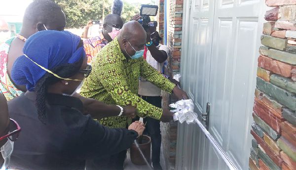 Mr Ishmael Ashitey (right), inaugurating the facility. With him is Dr Zanetor Agyeman-Rawlings (left), and Nii Tetteh Adjabeng (2nd left) Chief of Adabraka
