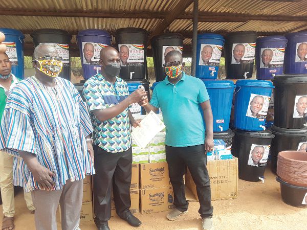  Mr Isaac Adongo (right) presenting a non-contact infrared thermometer to Mr Edmund Nyanwura