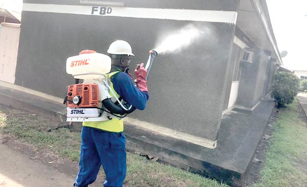 A staff of Aslord disinfecting a house at the VRA township 