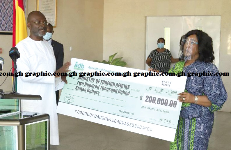 Mr Kennedy Agyapong (left) presenting a cheque to Ms Shirley Ayorkor Botchwey