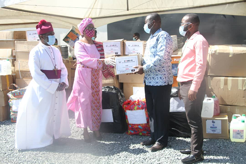Mrs Justice Sophia Akuffo (2nd left), Chairperson, National COVID-19 Trust Fund presenting presenting one of the items to Dr Lawrence Sreboe (2nd right), National Cardiothoracic Centre. With them are Justice Akrofi (left), a member of the Trust. Picture:Samuel Tei Adano