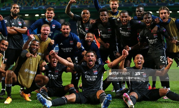 A triumphant Lyon side celebrating their victory over Manchester City