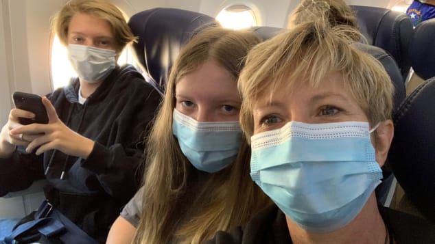 Stephanie Scherrer was on a flight with her two kids when she saw passengers removed from the airplane for refusing to wear masks.`