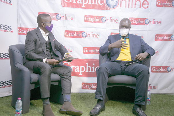 Mr Eli Hini (right), explaining a point to the host, Mr Charles Benoni Okine