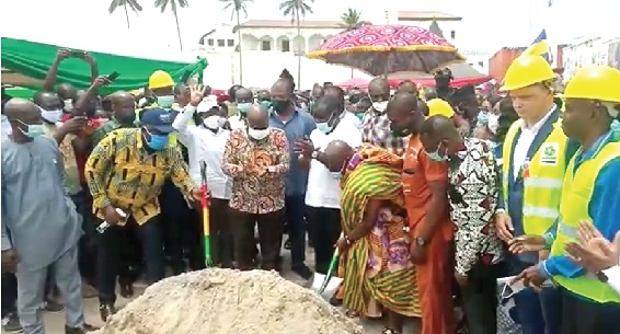 Nana Kwadwo Conduah (with shovel) cutting  the sod for the commencement of work on the project. Looking on is President Akufo-Addo (arrowed) and some dignitaries 