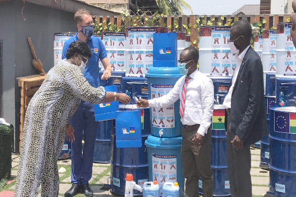 Ms Yvonne Quansah (left), presenting the PPE to Reverend Patrick Banafo at the event. Looking on is Mr Peter Smidt Van Gelder (2nd left) 