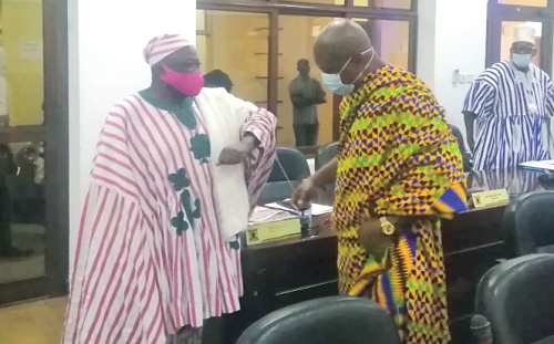 Togbe Afede XIV, the President of the National House of Chiefs, exchanging pleasantries with one of the members of the house