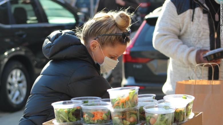Bride Emily Bugg prepares Thanksgiving meal packages for delivery to people with serious mental illnesses or substance abuse conditions. 