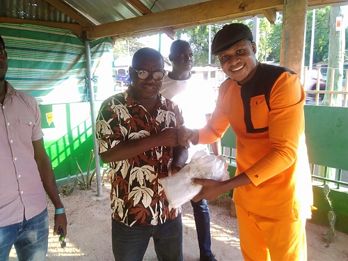 Mr Stephen Ngamegbulam(right) presenting the items to Mr Isaac Adongo,the incumbent MP for Bolgatanga Central and NDC parliamentary candidate