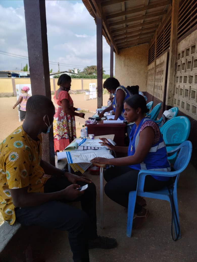 Ms Michelle Duker (right), Presiding Officer of Twedaase Primary Number 2, briefs Graphic Online about the peaceful and smooth voting exercise that was taking place at the station. With her, are Mr Godfrey Nyarko Anim, (left), Assistant Presiding Officer, and Ms Diana Teye (2nd right), Verification officer.