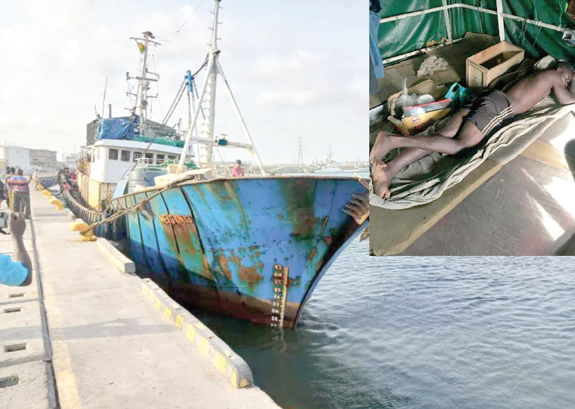A vessel with a worn-out look in dock at the Fishing Harbour. Inset: A local crew member resting on the deck of the vessel