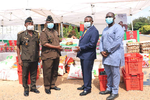Mr. Joe Mensah (2nd right) presenting the items to Mr. Samuel Adjei Attah (2nd left). Looking on are Mr. Raphael Tuekpe (left), Officer in charge, James Camp Prison and Mr. Benjamin Gyan-Kesse (right), Programme Director, Kosmos Innovation Centre. Picture: EDNA SALVO-KOTEY