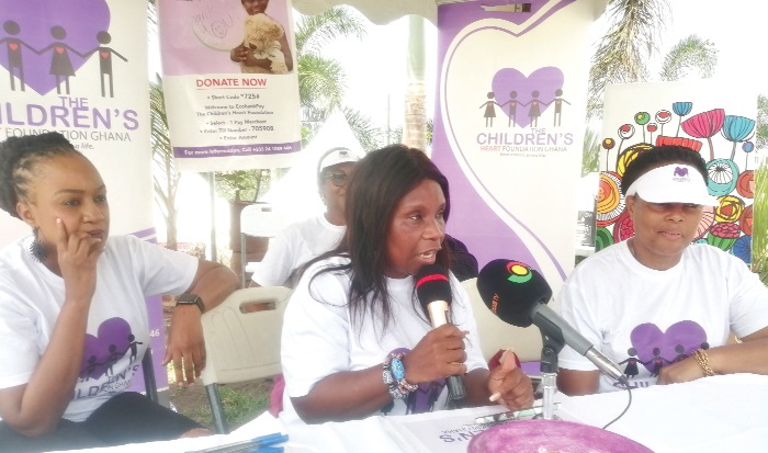 Mrs Jacqui Ahomka-Lindsay (middle) addressing the event. With him is Mrs Karen Hendrickson (right) and other trustees of the foundation
