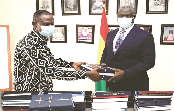 Alhaji Atchulo Yakubu (left) presenting the transitional handing over notes to the Chief Justice, Justice Kwasi Anin Yeboah