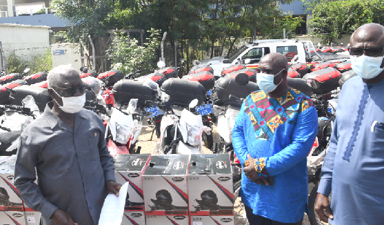Mr Yaw Osafo-Maafo (left), Senior Minister, handing over the vehicles and motorbikes to Mr Kingsley Asare Addo (middle), while Mr Kwasi Agyei Boateng, Deputy Minister of Local Government and Rural Development looks on