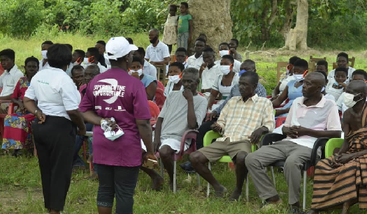 Mrs Elizabeth Adubofuor (left back to camera) engaging members of one of the communities during the outreach programme 