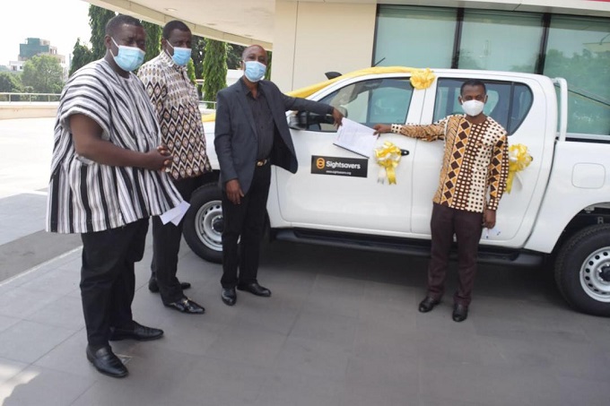 Mr David Agyemang (right) presenting document of the Toyota Hilux to Mr Kofi Asemanyi-Mensah.
