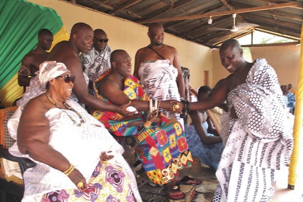 Nana Kwafo Akoto (seated) congratulating Nana Sumankwahene after the outdooring. Looking on is Nàna Afrakoma II, the Paramount Queenmother of the Akwamu Traditional Area 