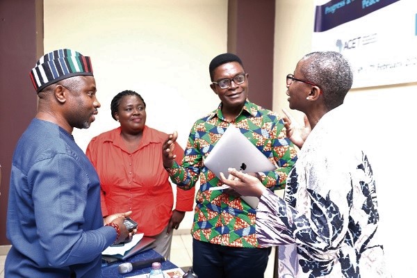 Dr Emmanuel Akwetey (2nd right) in a discussion with Dr Chukuemeka Eze (left), Dr Monde Muyangwa (right), Director, Africa Programme, Woodrow Wilson Centre, and Madam Levinia Addae-Mensah (2nd left), Programmes Director, WANEP. 