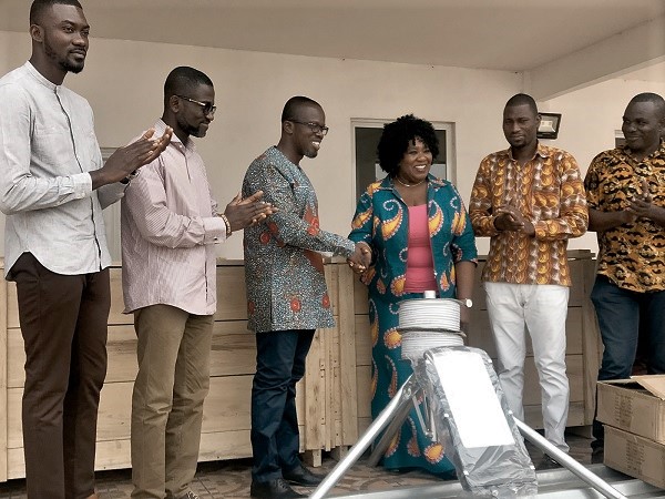 Ms Christine Dadson (3rd right), Executive Assistant to the Municipal Chief Executive, presenting some painting materials to Nana Otuo Owoahene Acheampong (3rd left), President of GAVA
