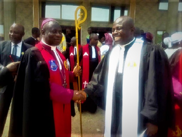 Rt Rev Andam (left) congratulating The Very Rev Kobena Appiah after the induction