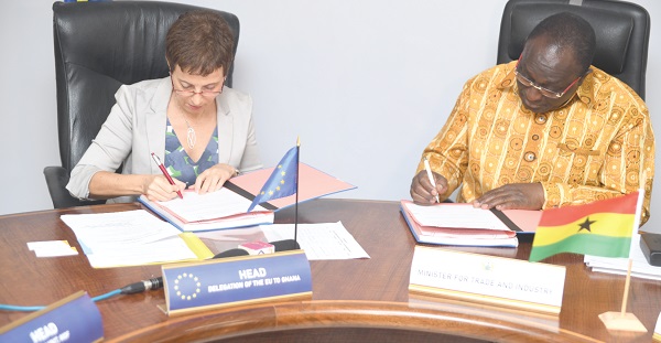 Mr Alan Kyerematen (right) and Mrs Diana Acconcia signing the documents for the grant agreement