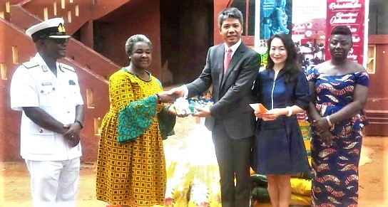Mr Yang Qun (3rd right), handing over the items to Rev. Mrs Georgina Happy Crentsil (2nd left). With them are Ms Heng Yue (2nd right), wife of Mr Qun, Mrs Cherub Kwateng (right), Tema East Sub Metro Director and Commodore Samuel Walker (left), Flag Officer Commanding, Eastern Naval Base