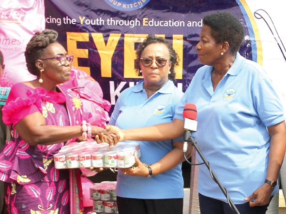 Mrs Akosua Newman (left), Director of Operations, Office of the First Lady, presenting the items to Ms Adjoa Amana (right), Director, EYEH Soup Kitchen and Ms Elizabeth Quashie-Idun (middle) at the event. 