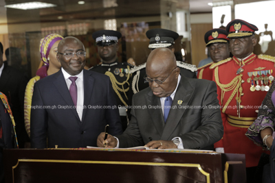 President Akufo-Addo signing the register at Parliament after his speech. With him is Vice-President Dr Mahamaudu Bawumia. PHOTO BY SAMUEL TEI ADANO