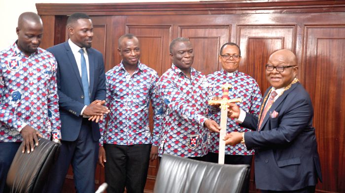Mr David Odjidja (4th left) presenting a sword to Professor Mike Oquaye. Looking on are Mr Emmanuel Akyemvi (3rd left), Assistant Headmaster, Admistraction; Mr Paul Kofi (left), Senior Housemaster, and Rev. Erasmus Laryea (2nd right), Chaplain, all of PRESEC, and Mr Leonard Akuffo-Kwapong (2nd left), the Global Organiser of PRESEC Old Boys.  Picture: Emmanuel Quaye