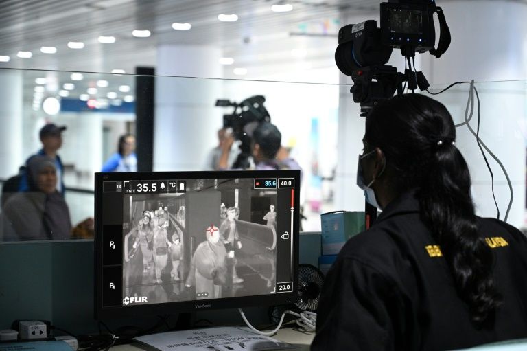 Traveller screening using temperature monitors and questionnaires is a key response measure to the emergency (AFP Photo/MOHD RASFAN)