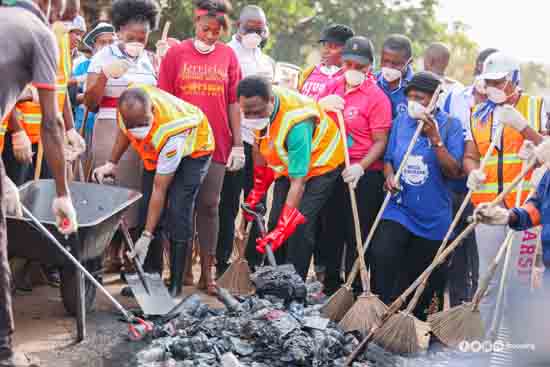 Apostle Eric Kwabena Nyamekye (3rd left with a shovel) and some  members of the church during the sanitation campaign  to rid the country of filth