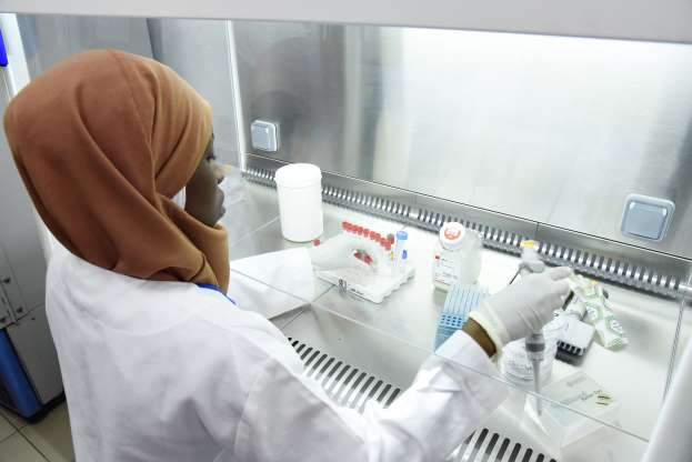 A scientific staff member works in a secure laboratory, researching the coronavirus, at the Pasteur Institute in Dakar on February 3, 2020. - The Pasteur Institute in Dakar, designated by the African Union as one of the two reference centres in Africa for the detection of the new coronavirus that appeared in China, is hosting experts from 15 countries on the continent this weekend to prepare them to deal with the disease. (Photo by Seyllou / AFP) (Photo by SEYLLOU/AFP via Getty Images)