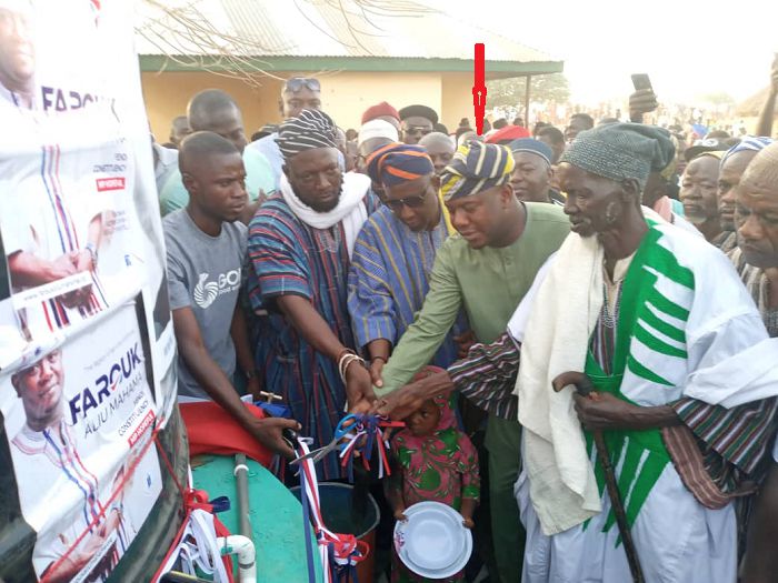 Alhaji Farouk Aliu Mahama (arrowed) cutting tape to inaugurate the water facility