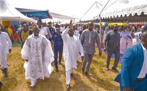 Vice-President Dr Mahamudu Bawumia (hand raised) acknowledging cheers from the crowd. On his right is Maulvi Mohammed Bin Salih