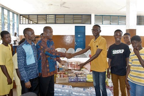 Mr Frederick Tetteh (3rd left) receiving the items from Collins Annowi (3rd right). Picture: Patrick Dickson 