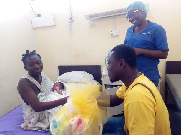  New mother receiving a hamper from official of MTN Pic2: Mr Owusu Nyarkoh presenting a hamper to one of the new mother