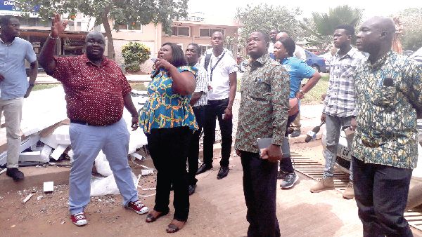 Mr Richmond Owusu (left) explaining the point  to some staff of the Korle Bu Teaching Hospital and the MiDA team 