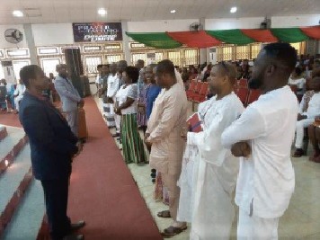Executives of the NDC (right) being prayed for by some pastors of the Winners Chapel International at Ho Dome during the thanksgiving service.