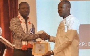 Mr Emmanuel Attafuah-Danso (right) presenting a certificate to the Chairman of the Middle East branch, Mr Isaac Osea. 